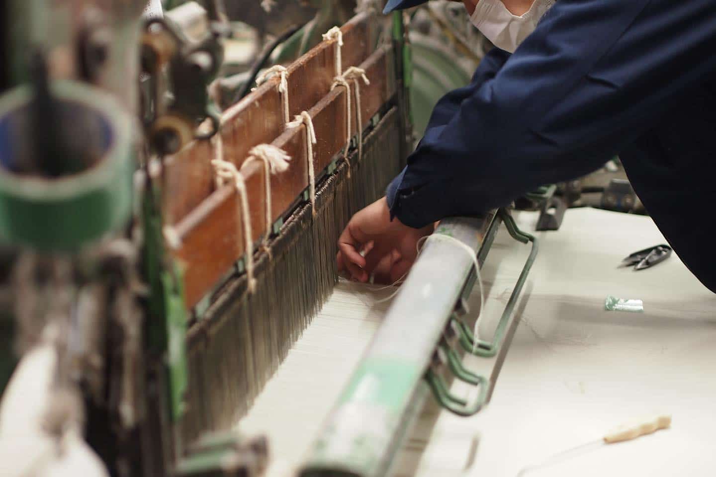Craftsperson working at a loom in the Takeyari factory